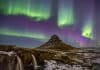 Winter landscape in Iceland with the Northern Lights dancing in the sky
