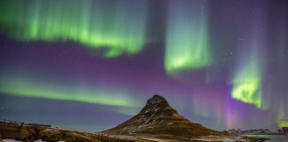 Winter landscape in Iceland with the Northern Lights dancing in the sky