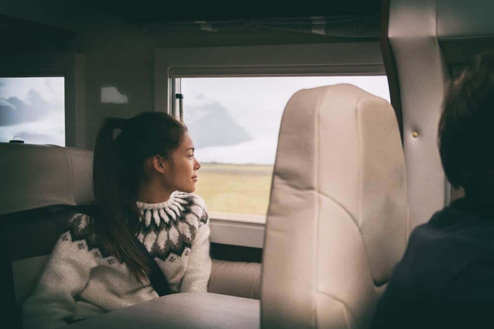 Woman in rental motorhome admiring Iceland's countryside