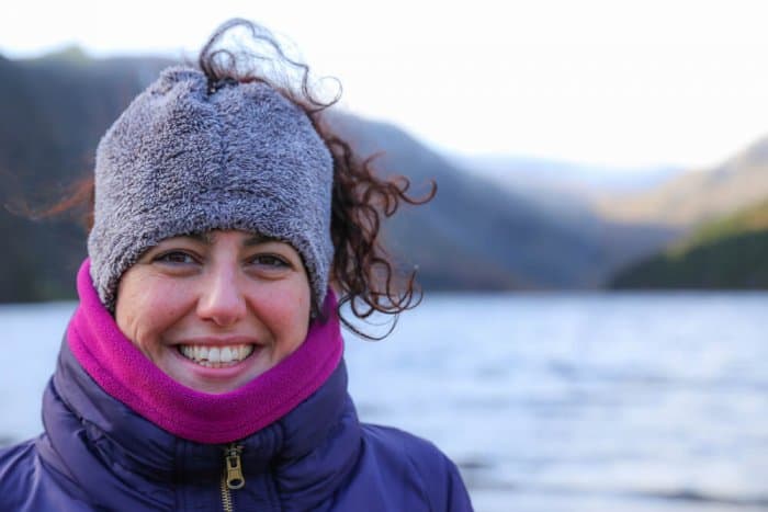Woman dressed in many layers for cold day by the lake