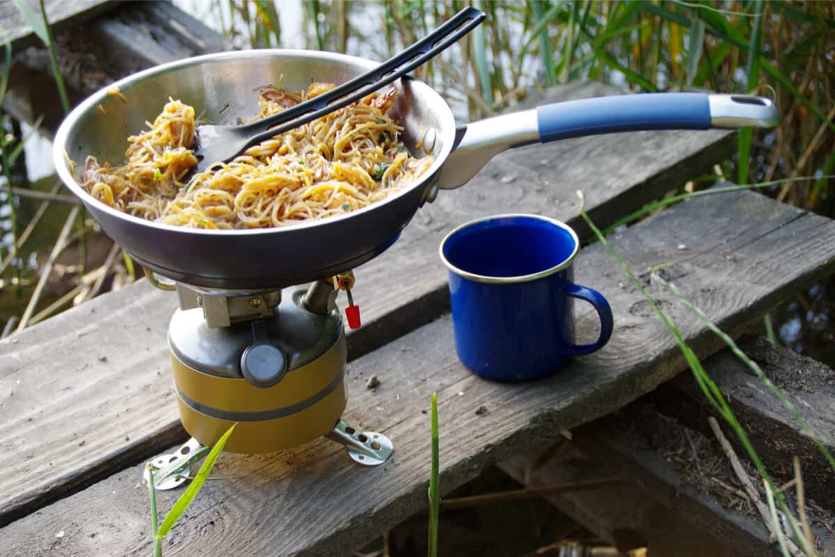 Skillet cooking dinner over camping stove