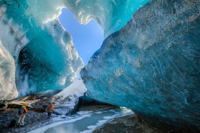 Tourists inside an ice cave in Iceland in December