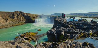 Group of tourists standing at the edge of the Dettifoss waterfall