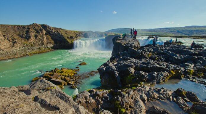 Group of tourists standing at the edge of the Dettifoss waterfall