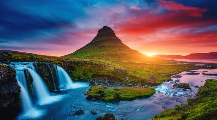 Kirkjufell volcano at sunset in Iceland with waterfall