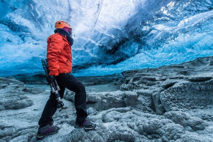 Woman hiking in a glacier, activity available within our 7-Day Ring Road Itinerary