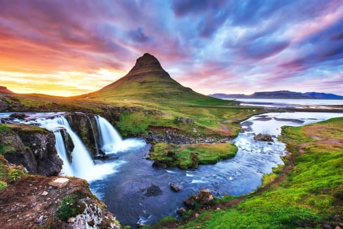 Kirkjufell mountain and Kirkjufellsfoss waterfall at sunset are one of Iceland's best photography locations