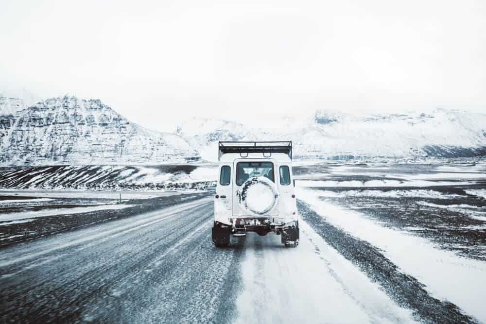 A jeep rental covered by insurance on an icy Iceland road