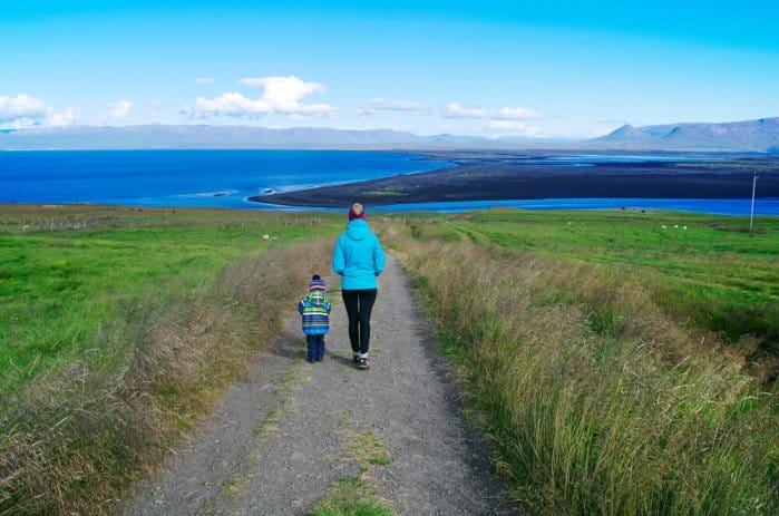 Mother and son walk during Iceland family vacation