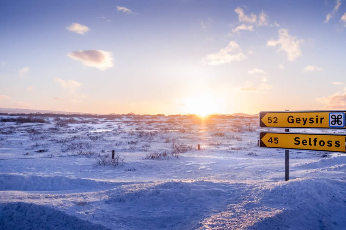 Road signs during Iceland in February with snowy landscapes