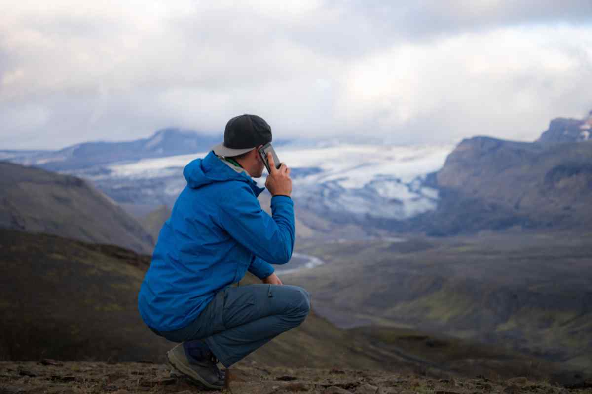Tourist making a call in a remote region of Iceland