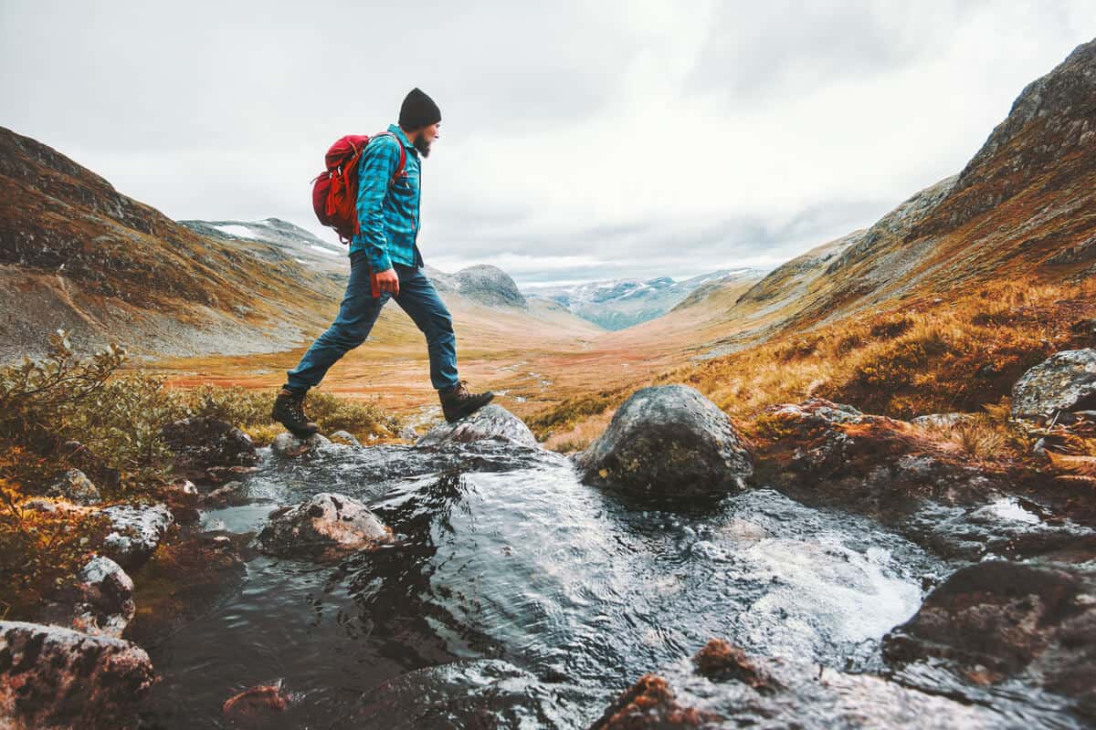 Iceland solo travel man backpackpacking across Landmannalaugar