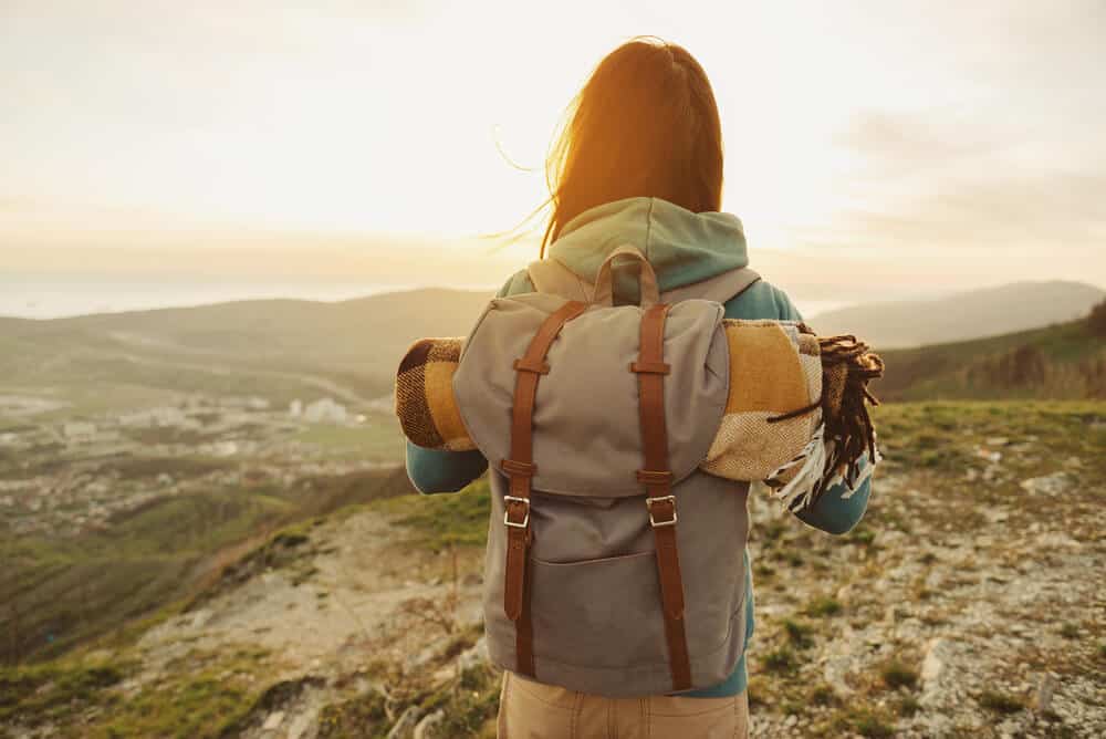 Young woman overlooking Icelandic landscape contemplating sustainable tourism