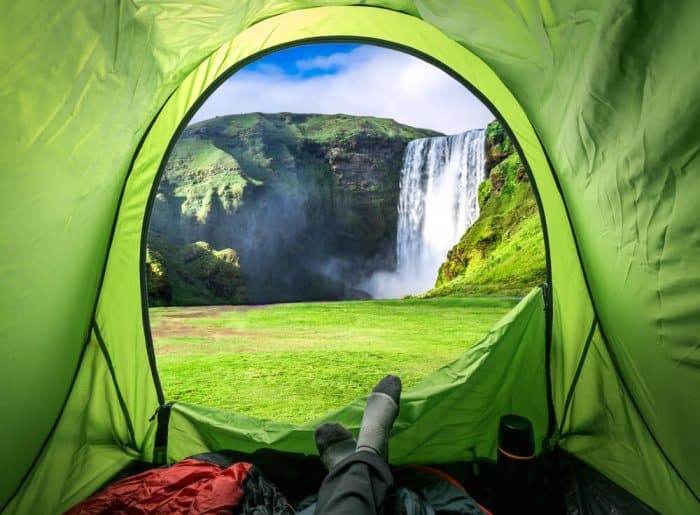 Camping in Iceland in June with a view of a waterfall