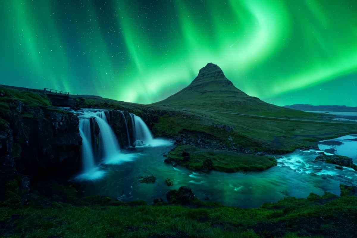 Northern lights dancing over kirkjufellsfoss