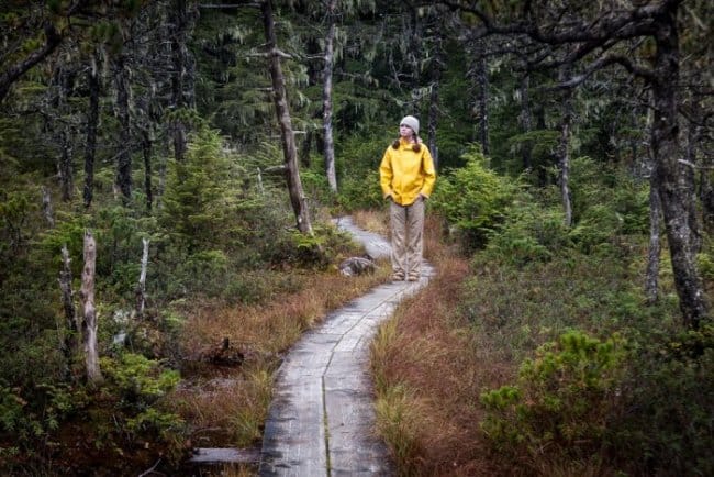 Woman walking in Iceland in yellow rain jacket