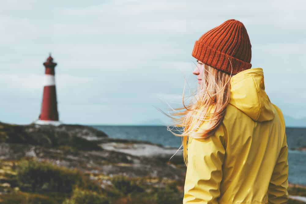 Girl wearing a raincoat which is a must in this packing list Iceland