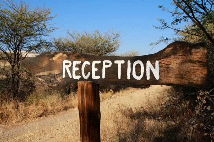 Wooden reception sign at check-in