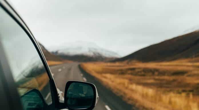 View from the side of a camper on a road trip