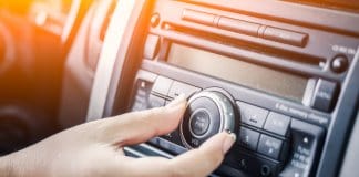 Woman turning up her playlist for best road trip songs