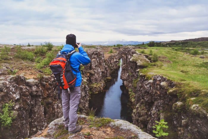Visitor taking a photo to the landscape of Thingvellir National Park