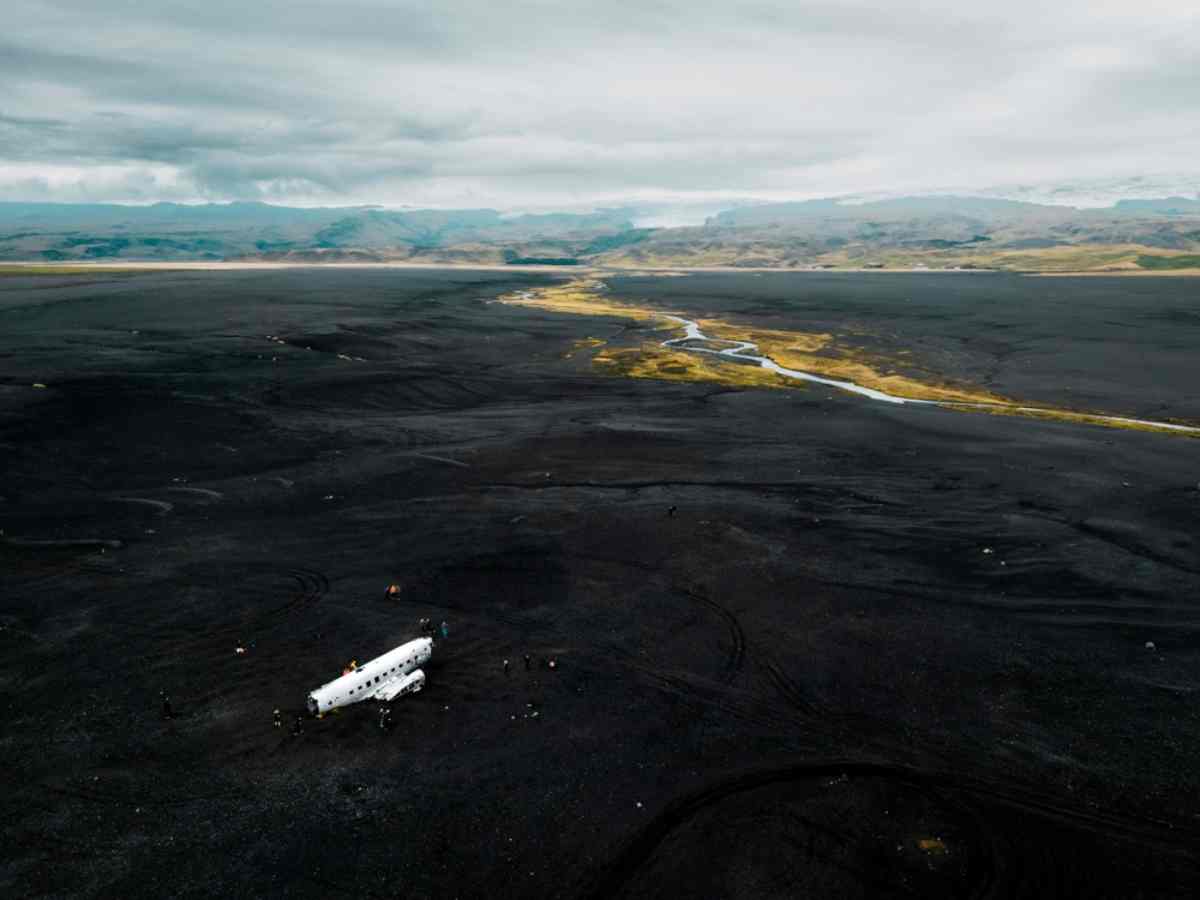 black sand beach and wrecked plane