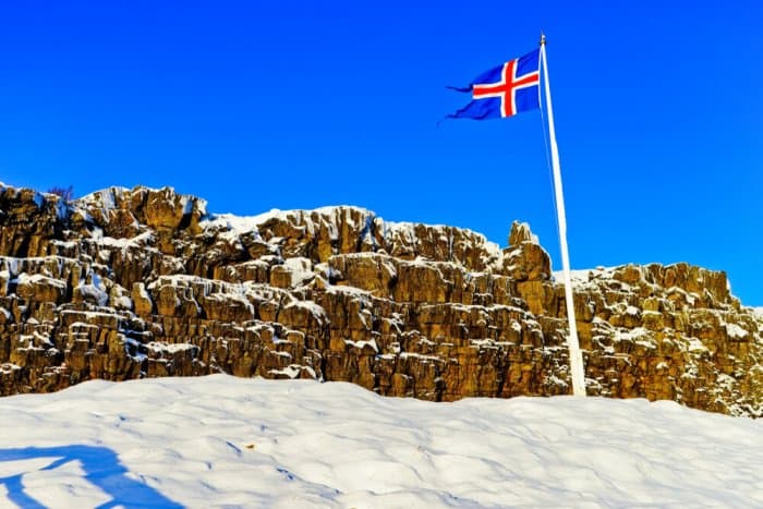 Flag of Iceland waiving at the point where the parliament was set in Thingvellir National Park