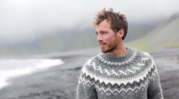 Handsome Icelandic man having a walk along the black sand beach in Iceland