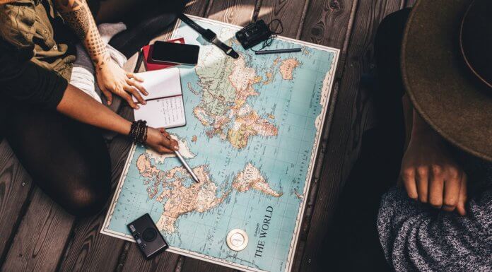 People planning their Iceland trip with a map