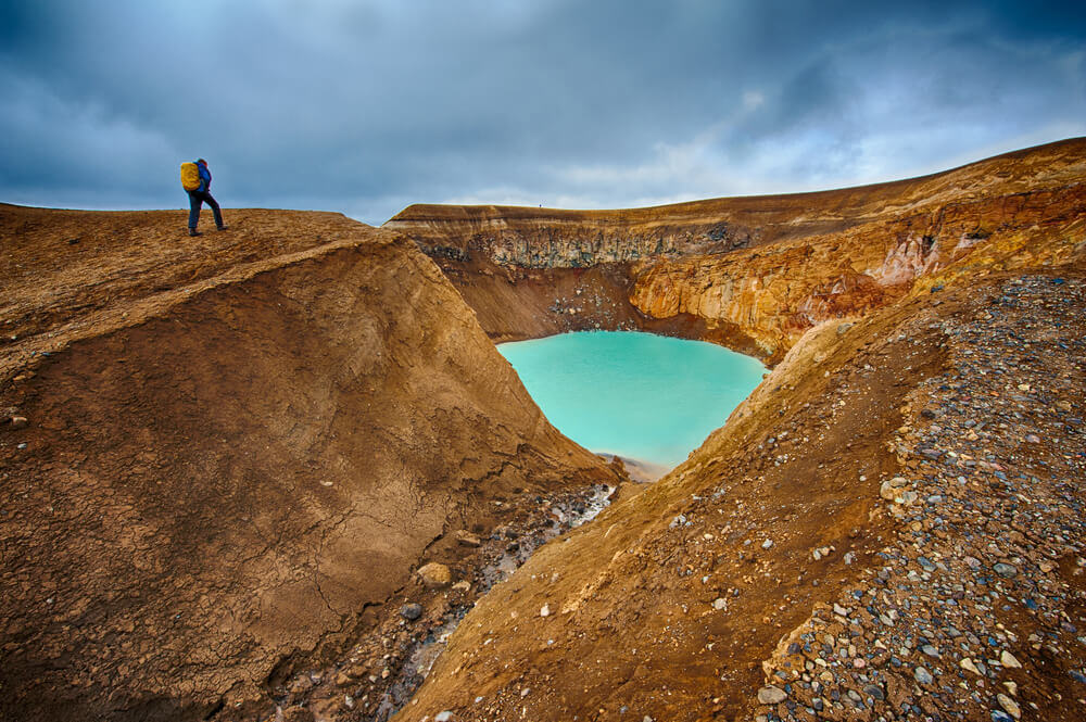 yellowish icelandic volcano caldera with water in it