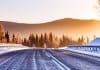 Icy winter road with mountains in background