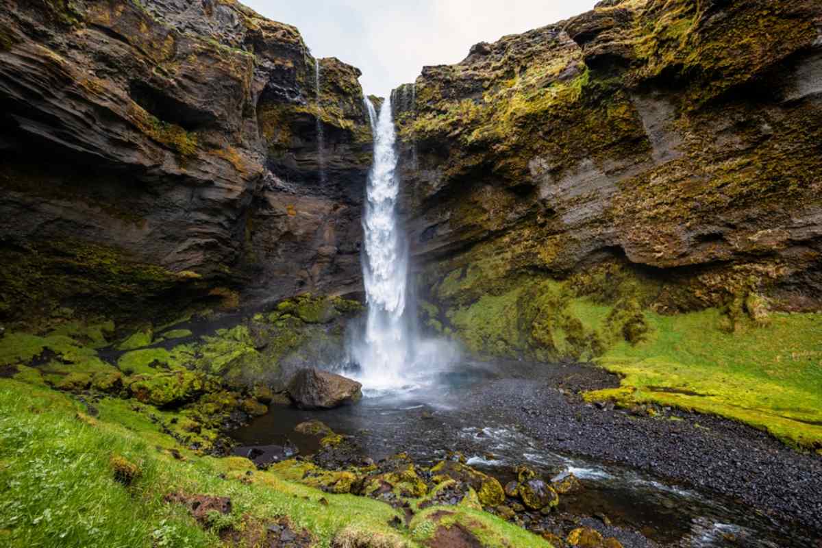 Waterfall in a scenic landscape with lush greenery